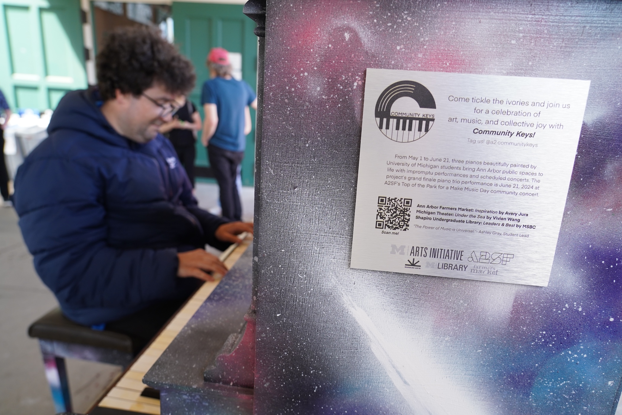 Someone plays one of the Community Keys pianos.