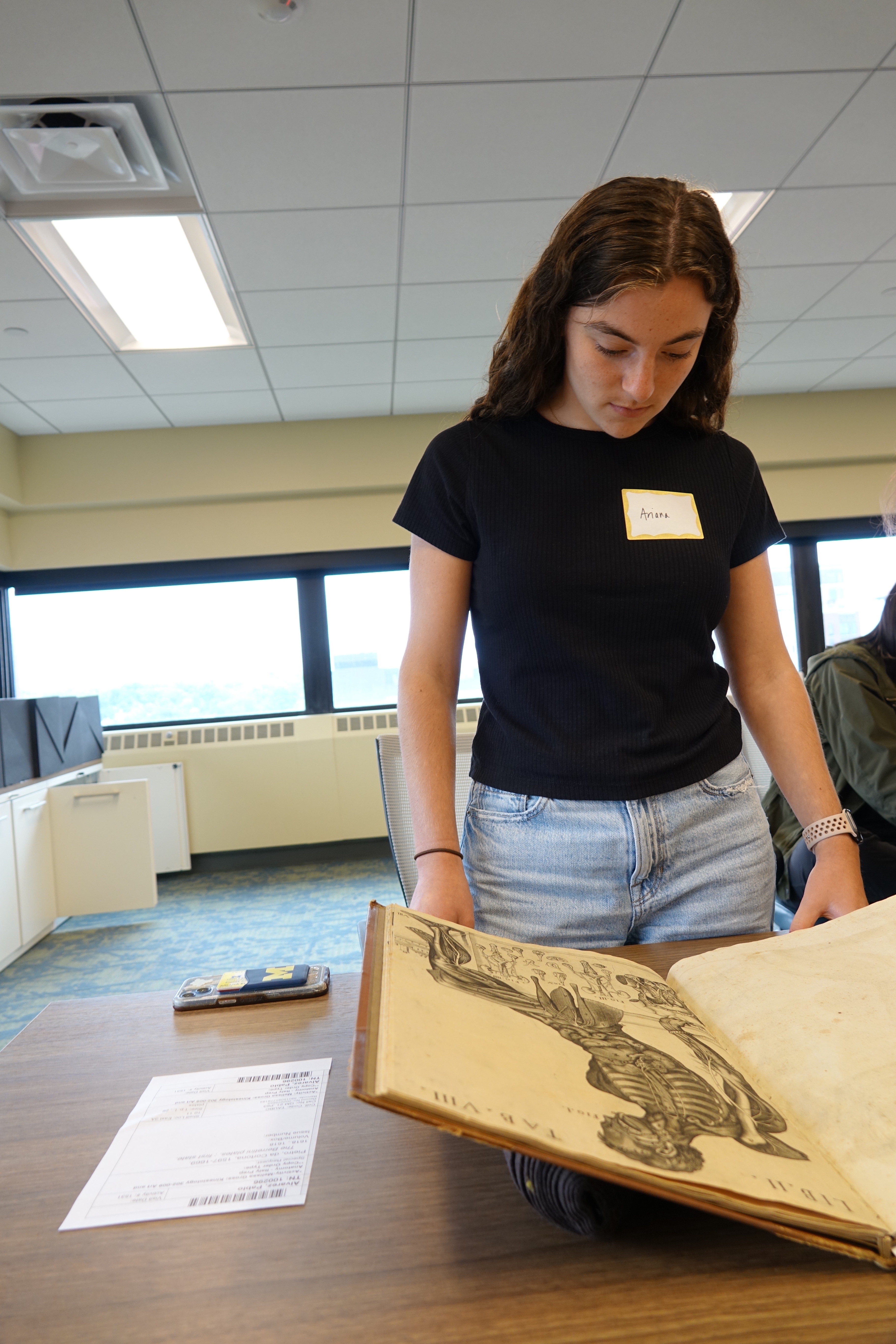 Ariana Ravitz looking at ancient anatomy books