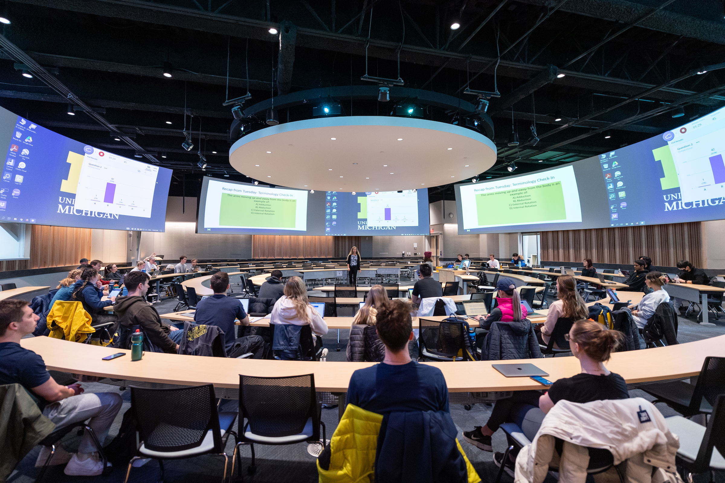 DeJong Lempke teaching "Topics in Human Performance" in the Central Campus Classroom Building's Classroom in the Round