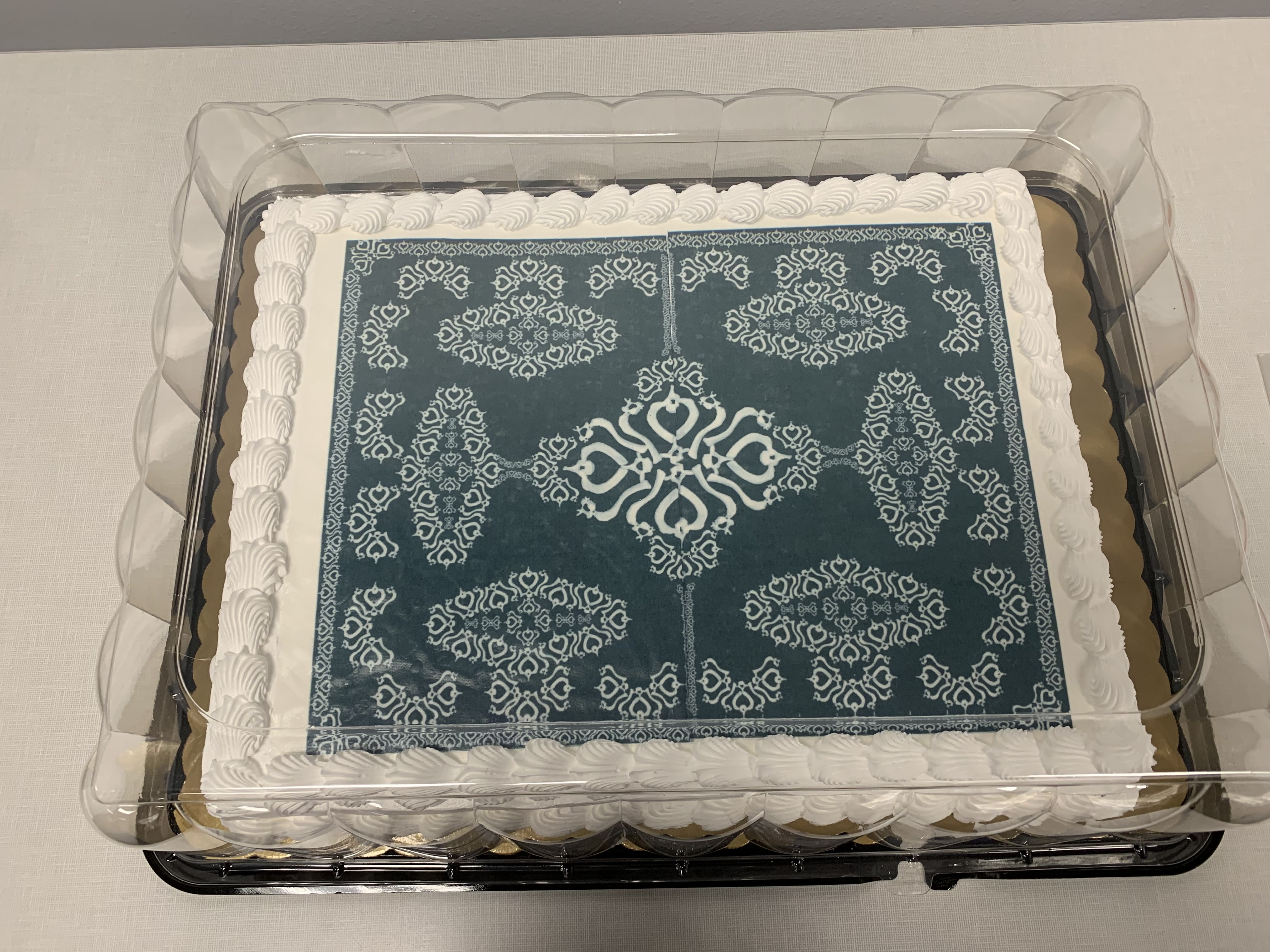 A cake with an artistic pattern made from repeating bone patterns