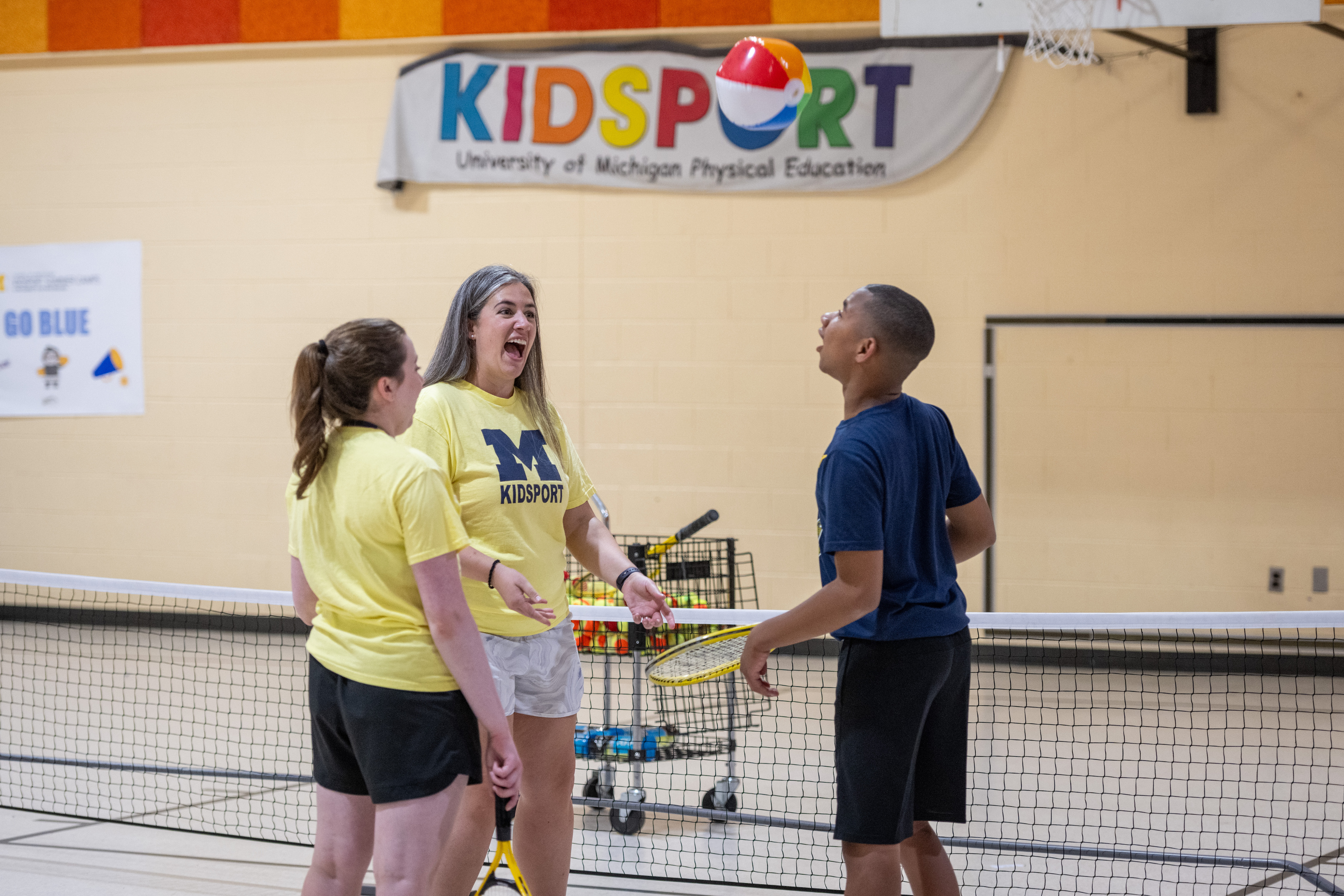 KidSport Adaptive camper Rob bounces a beach ball on his tennis racket.