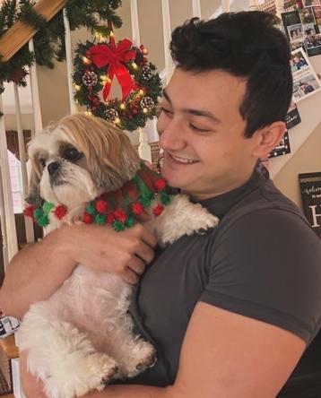 CJ Ferrante with a dog at the holidays