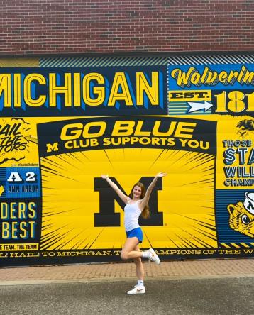 Lauren Strefling in front of a University of Michigan mural