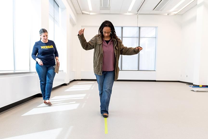 Study subject walks a straight line while Dr. Haylie Miller looks on.