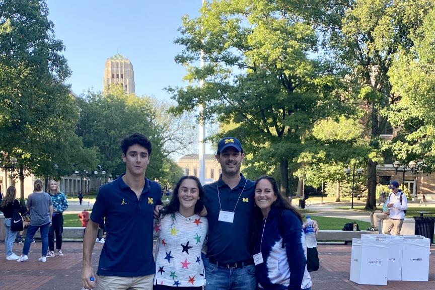 Alum Scott Doyne stands on the Diag with his family.