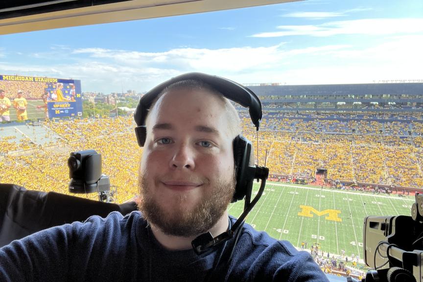 David Woelkers Jr. at a U-M football game in the broadcasting booth