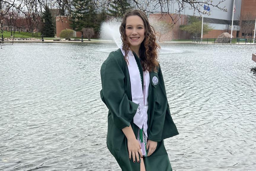 Melissa Siemen in a graduation robe at Eastern Michigan University