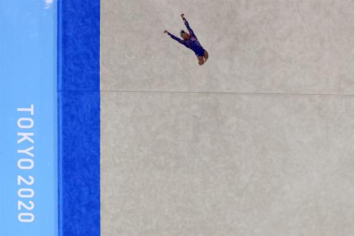 Athlete tumbling on floor mat