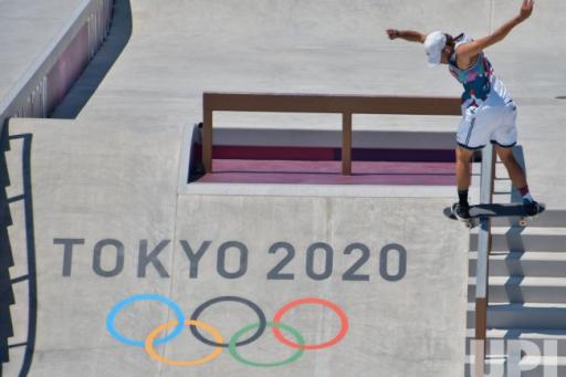 A skateboarder practices as the Olympic Skate Park